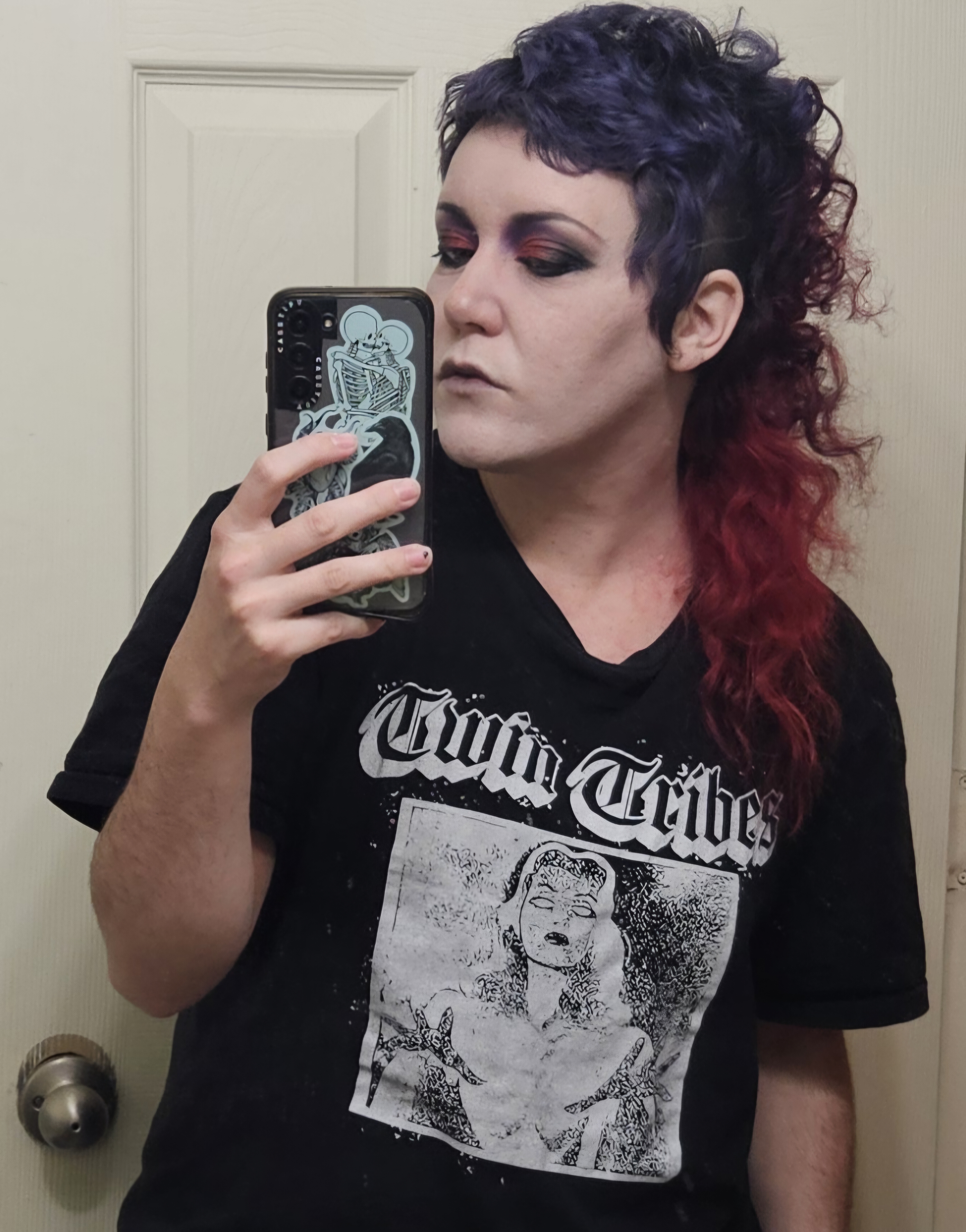 A picture of the website owner with curly red and blue hair